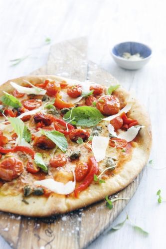 Pizza de mozzarella de buffalla, albahaca y tomates cherry