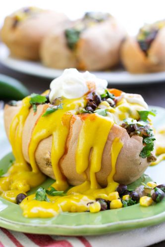 vegan stuffed sweet potatoes with black beans and kale